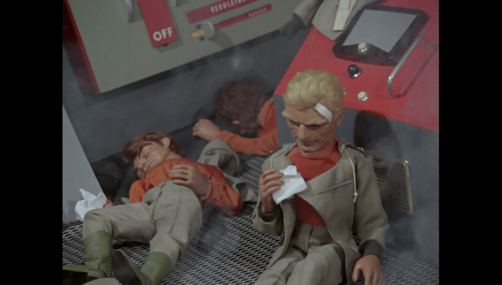 The Sidewider crew, including Colonel Sweeney, overwhelmed by the smoke in the Thunderbirds episode, Pit of Peril.