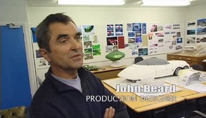 Thunderbirds Production Designer, John Beard interviewed during production surrounded by concept art and models of FAB 1 and Thunderbird 2